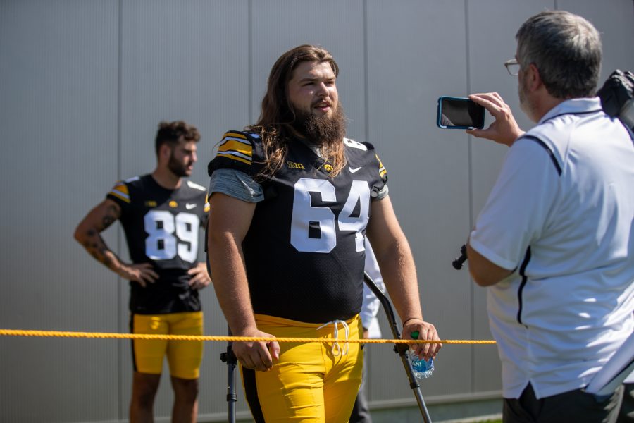 Iowa right guard Kyler Schott converses with a reporter during Iowa football media day at Iowa football’s practice field on Friday, Aug. 13, 2021.