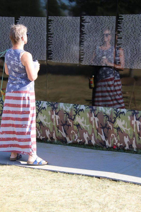 A visitor takes time to reflect on the meaning of the Moving Wall on Monday, Aug. 16, 2021.