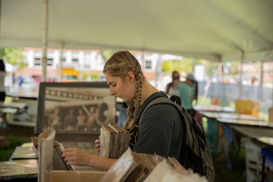 University of Iowa sophomore Mikala Staerzl looks for small posters to hang in her apartment during the poster sale at Hubbard Park on Thursday, Aug. 26, 2021. 