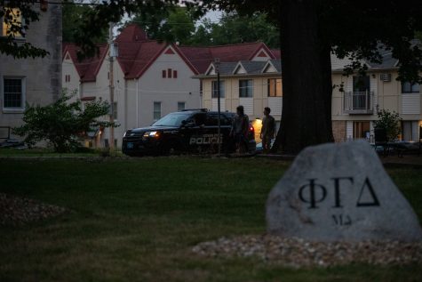 A police car sits in front of the Phi Gamma Delta fraternity house during a protest following sexual assault allegations against the University of Iowa’s chapter of Phi Gamma Delta on Tuesday, Aug. 31, 2021. 