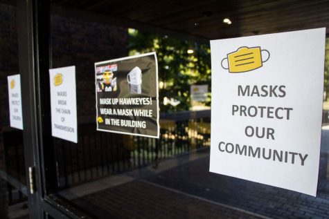 Signs encouraging students to wear masks in classrooms are seen on the doors of the English-Philosophy Building at the University of Iowa on Monday, Aug. 23, 2021.