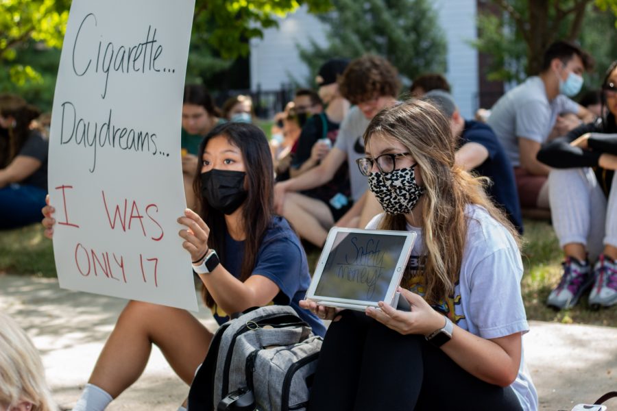 Protesters hold up signs outside of the University of Iowa President’s Residence following sexual assault allegations against the University of Iowa’s chapter of Phi Gamma Delta on Wednesday, Sept. 1, 2021. 