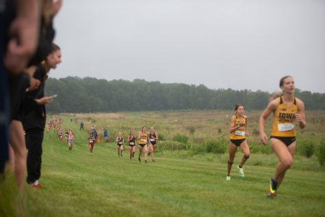 University of Iowa runner Miriam Sandeen climbs the hill toward the finish line behind teammates Lauren McMahon and Emma Gordon at the Ashton Cross Country Course on Friday, Sept. 3, 2021. Sandeen finished 22nd in the 4K with a time of 14:28.8. 