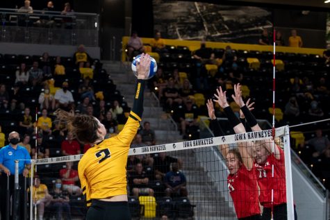 Right side Courtney Buzzerio goes for a kill against two Ball State blockers during the volleyball match between Iowa and Ball State on Friday, Sept 10, 2021. The Cardinals defeated the Hawkeyes 3-2. 