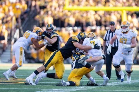 Iowa defensive linemen Zach VanValkenburg and Lukas Van Ness combine for a sack on Kent State quarterback Dustin Crum during a football game between Iowa and Kent State at Kinnick Stadium on Saturday, Sept. 18, 2021. The Hawkeyes defeated the Golden Flashes 30-7. 