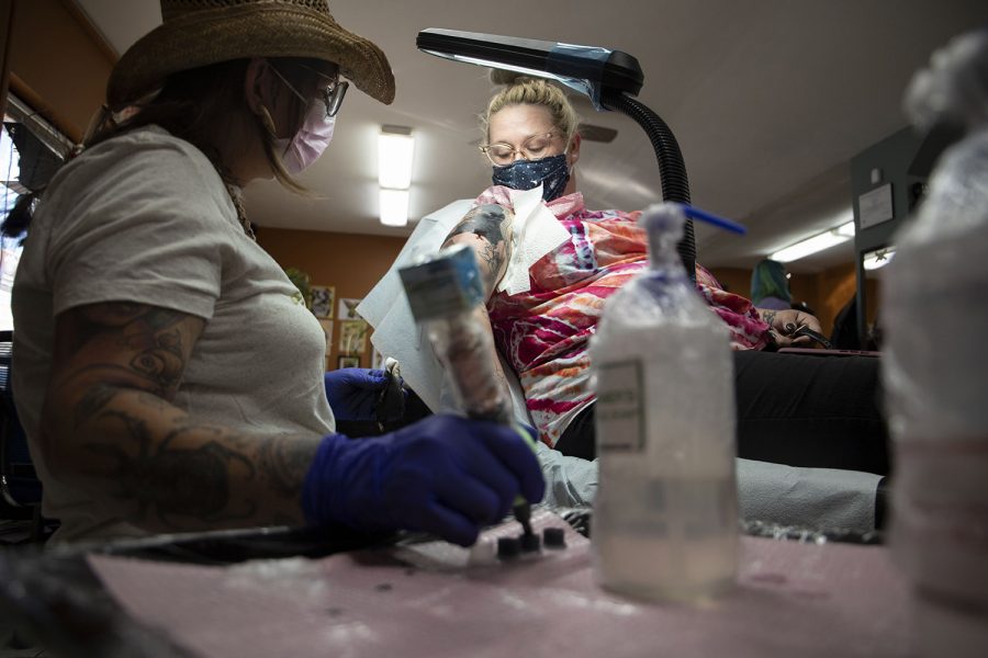 Kayla Way’s arm bleeds while Michelle Balhan tattoos her blackout sleeve at Velvet Lotus Tattoo on Thursday, Sept. 23. Way works part time at Velvet Lotus, and she gets tattoos from artists at the shop often. “I love having her art on my body,