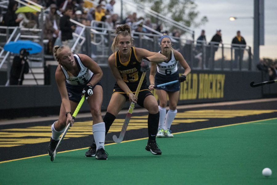 Iowa forward Leah Zellner looks to defender Penn State forward Meghan Reese as she passes to her teammate at Grant field on Friday Sept. 24, 2021. The Hawkeyes defeated the Lions 1-0.