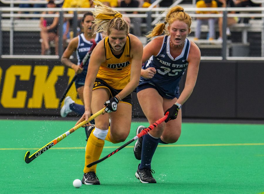Iowa and Penn State fight for position during a field hockey game between Iowa and Penn State on Sunday, Sept. 26, 2021, at Grant Field. The Hawkeyes defeated the Nittany Lions 4-0.