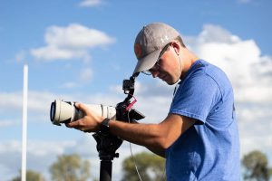 University of Iowa junior Kayd Nissen records footage at a Clear Creek Amana high school football practice on Wednesday, Sept. 8, 2021.