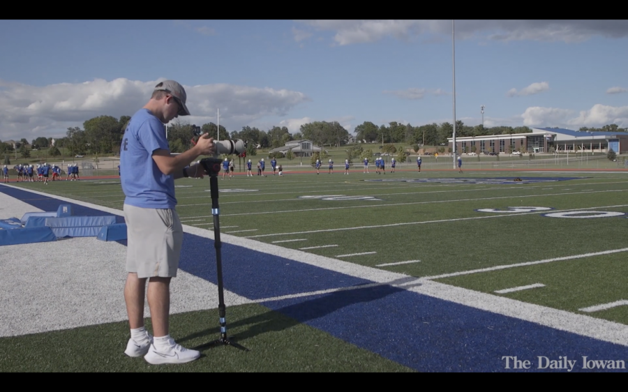 Student videographer Kayd Nissen films a high school football team. 