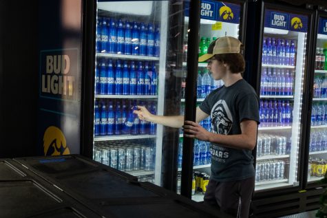 A concession stand attendant serves an alcoholic beverage during a football game between No. 18 Iowa and No. 17 Indiana at Kinnick Stadium on Saturday, Sept. 4, 2021. The Hawkeyes defeated the Hoosiers 34-6. This is the first season Kinnick Stadium has sold alcohol.