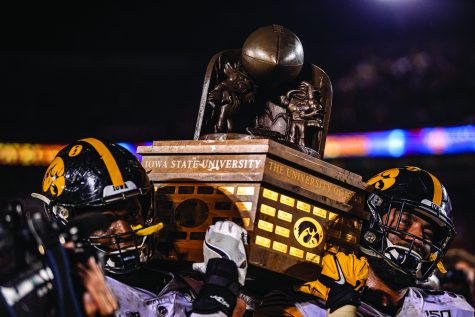 Iowa players hoist the Cy-Hawk trophy during a football game between Iowa and Iowa State at Jack Trice Stadium in Ames on Saturday, September 14, 2019. The Hawkeyes retained the Cy-Hawk Trophy for the fifth consecutive year, downing the Cyclones, 18-17. 