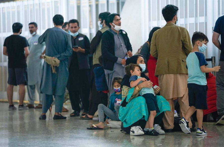 Aug 26, 2021; Dulles, VA, USA; Afghan refugees arrive at Dulles International Airport in Northern Virginia while en route to military facilities in the U.S.  Mandatory Credit: Jack Gruber-USA TODAY