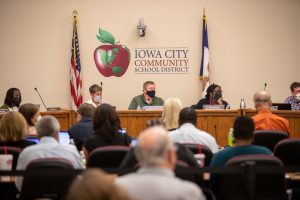 Members of the Iowa City Community School District Board listen to members of the crowd during an Iowa City Community School District meeting in Iowa City on Tuesday, Sept. 14, 2021. 