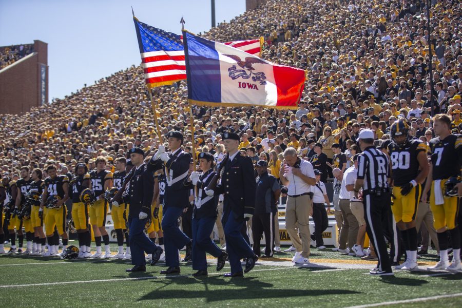The American flag and the state of Iowa flag are presented before a game during a football game between Iowa and Colorado State at Kinnick Stadium on Saturday, Sept. 25, 2021. The Hawkeyes defeated the Rams 24-14. 