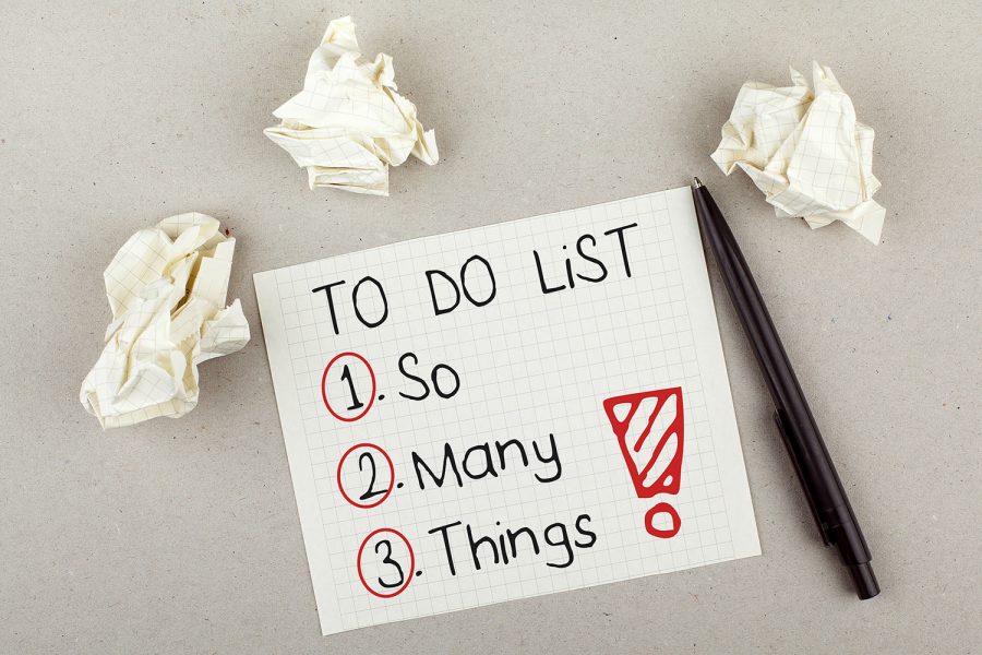 To do list with so many things note on paper with paper balls and pen