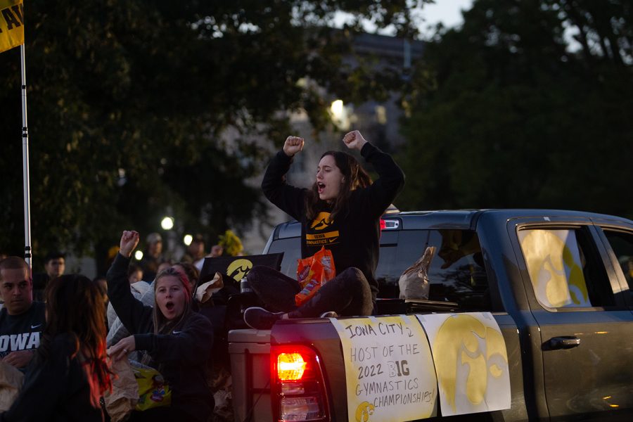 A University of Iowa gymnastics member gets pumped during the Iowa Hawkeyes homecoming parade in Iowa City on Friday, Oct. 15, 2021. 