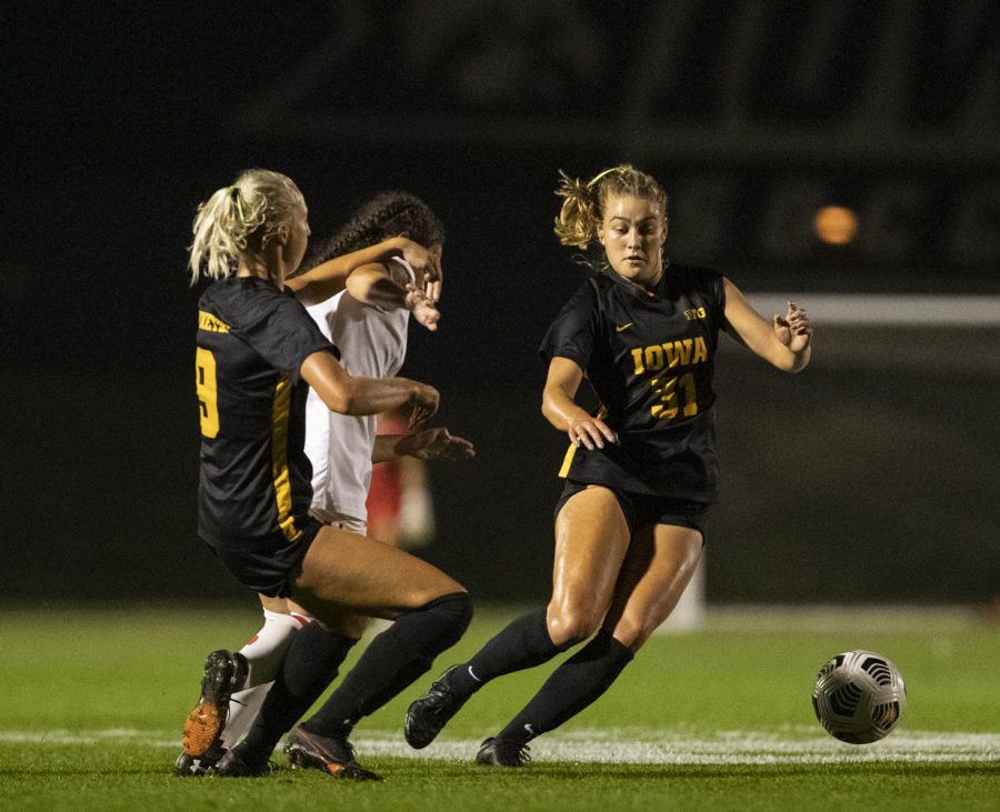 Iowa defender Samantha Cary and midfielder Addie Bundy scramble to keep the ball away from Maryland during a soccer game between Iowa and Maryland at the UI Soccer Complex on Sept. 30, 2021. The Hawkeyes defeated the Terrapins 2-1.