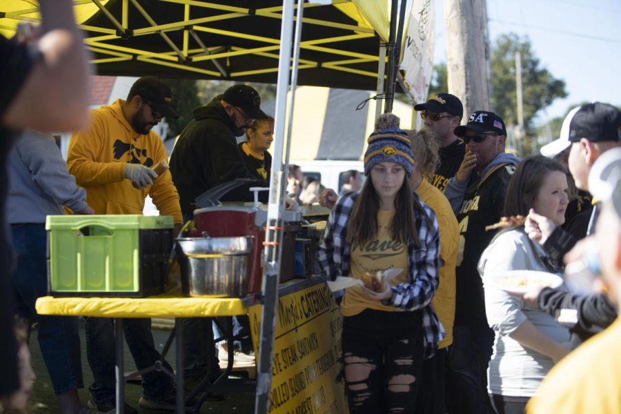 Tailgaters grab food before Iowa’s homecoming game against Purdue on Saturday, Oct. 16, 2021. 