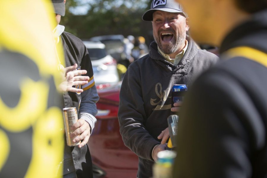 During the University of Iowa homecoming game against Purdue on Saturday, Oct. 16, 2021, Iowa fans play new tailgating game. The objective of the game is to hit the nail flush against the log.