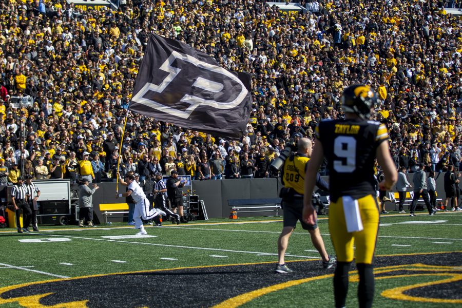 A member of the Purdue spirit squad runs a flag on the field during a football game between No. 2 Iowa and Purdue at Kinnick Stadium on Saturday, Oct. 16, 2021. The Boilermakers defeated the Hawkeyes 24-7. (Jerod Ringwald/The Daily Iowan)