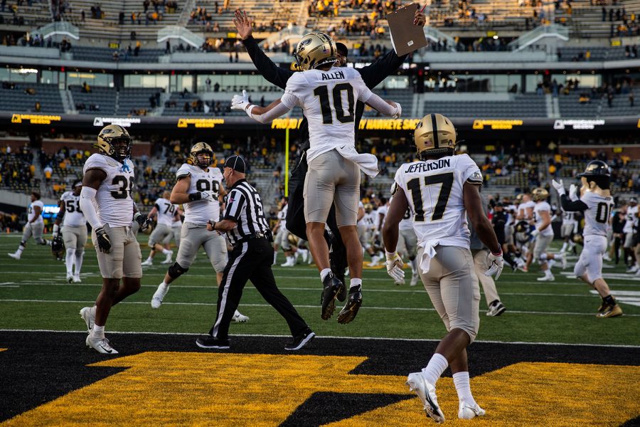 Purdue safety Cam Allen celebrates with a coach after a football game between No. 2 Iowa and Purdue at Kinnick Stadium on Saturday, Oct. 16, 2021. The Boilermakers defeated the Hawkeyes 24-7. 