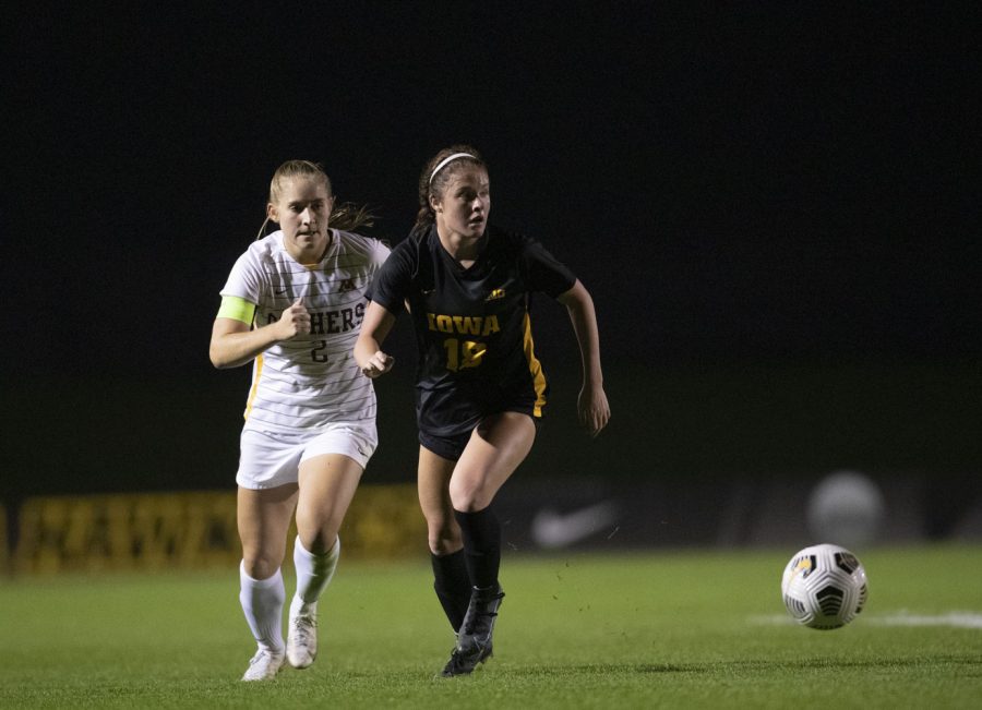 University of Iowa forward Courtney Powell and University of Minnesota defender Makenzie Langdok race towards the ball during a soccer game between Iowa and Minnesota at the UI Soccer Complex on Thursday Oct. 21, 2021. The Hawkeyes defeated the Gophers 1-0. 