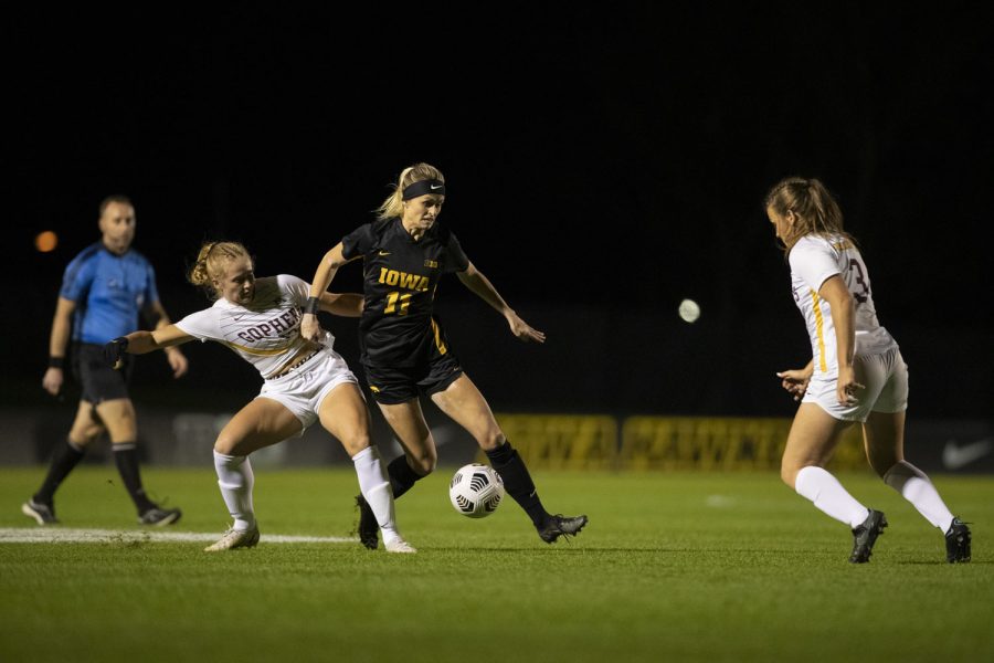 University of Iowa forward Alyssa Walker pushes University of Minnesota defender Abi Frandsen to move the ball around University of Minnesota defender Delaney Stekr during a soccer game between Iowa and Minnesota at the UI Soccer Complex on Thursday Oct. 21, 2021. The Hawkeyes defeated the Gophers 1-0. 