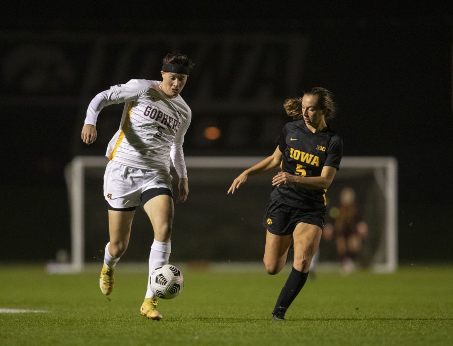 University of Minnesota forward Rylan Baker pushes the ball upfield while University of Iowa defender Riley Whitaker looks to steal the ball during a soccer game between Iowa and Minnesota at the UI Soccer Complex on Thursday Oct. 21, 2021. The Hawkeyes defeated the Gophers 1-0. 