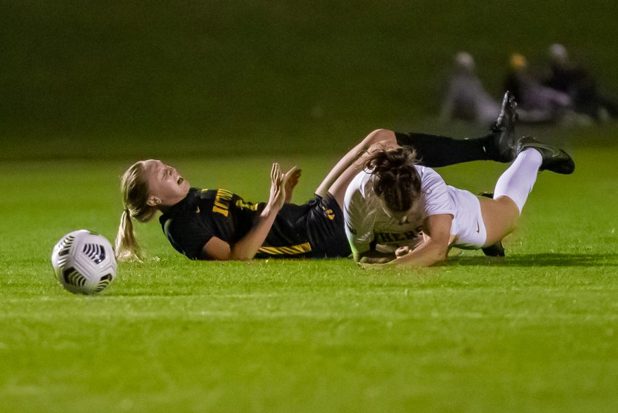 An Iowa and Minnesota player are shown on the ground during a soccer game between Iowa and Minnesota at the UI Soccer Complex in Iowa City on Thursday, Oct. 21, 2021.The Hawkeyes defeated the Gophers 1-0. 
