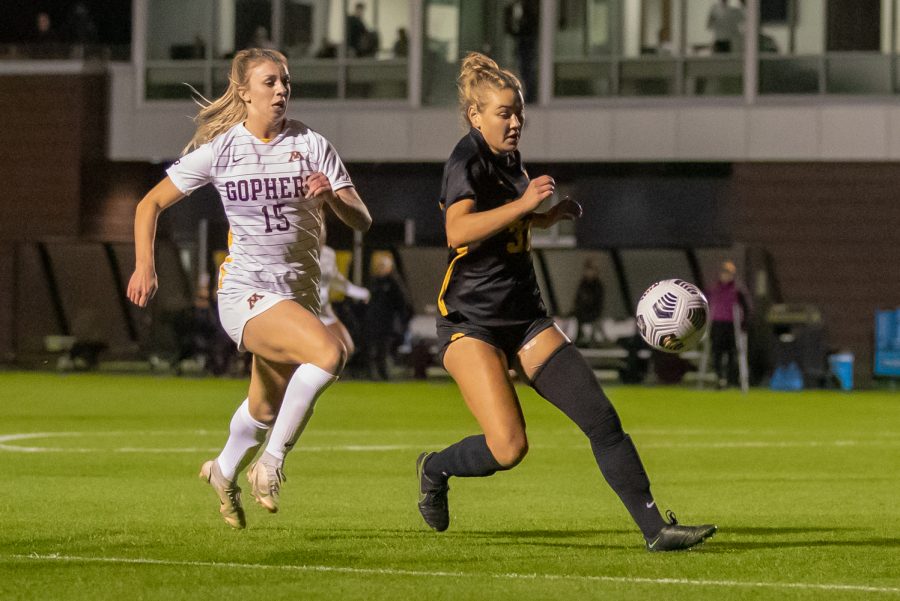 Minnesota forward McKenna Buisman attempts to run past Iowa defender Addie Bundy for the ball during a soccer game between Iowa and Minnesota at the UI Soccer Complex in Iowa City on Thursday, Oct. 21, 2021.The Hawkeyes defeated the Gophers 1-0. 