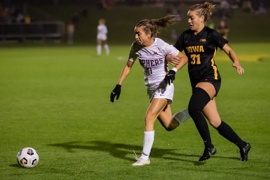 Iowa midfielder Addie Bundy and Minnesota midfielder Sophia Boman both contest for the ball during a soccer game between Iowa and Minnesota at the UI Soccer Complex in Iowa City on Thursday, Oct. 21, 2021.The Hawkeyes defeated the Gophers 1-0. 