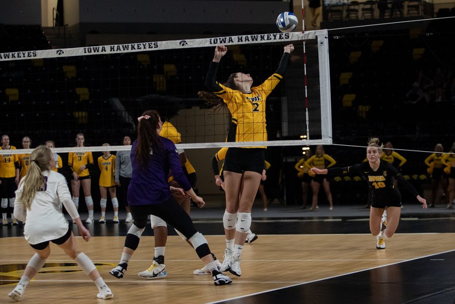 Iowa right-side hitter Courtney Buzzerio reaches for the ball during a volleyball match at Xtream Arena in Iowa City on Saturday, Oct. 16, 2021. The Wildcats defeated the Hawkeyes 3-0.