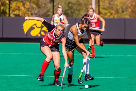 Iowa forward Ciara Smith and Ohio State back Olivia Zettervall try to gain possession of the ball during the field hockey game between Iowa and Ohio State at Grant Field on Sunday, Oct. 17, 2021. Iowa defeated Ohio State 3-0. 