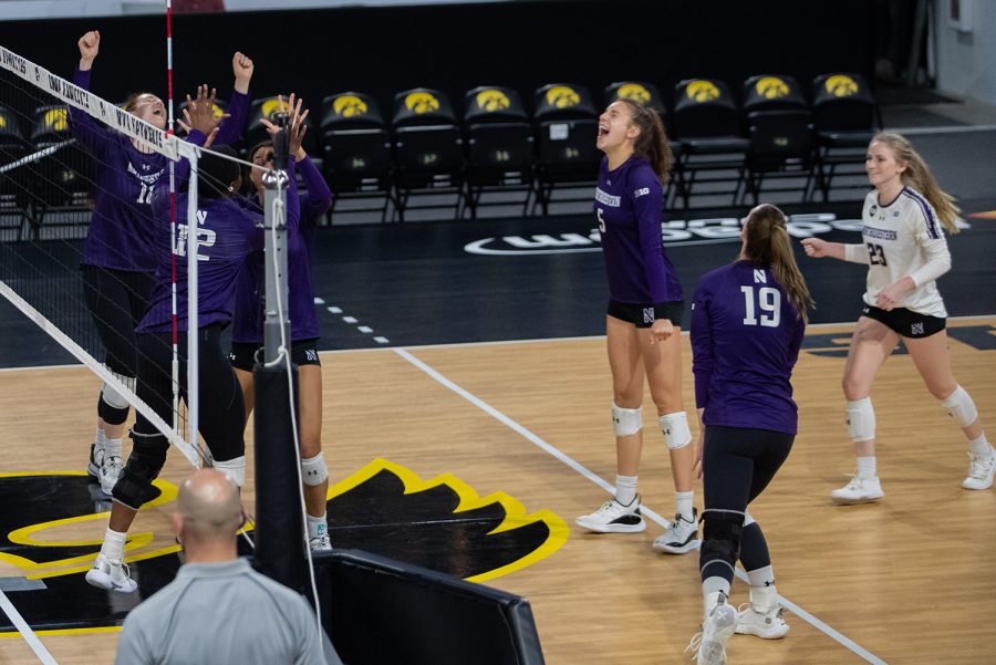 Northwestern celebrates a point scored during a volleyball match at Xtream Arena in Iowa City on Saturday, Oct. 16, 2021. The Wildcats defeated the Hawkeyes 3-0.