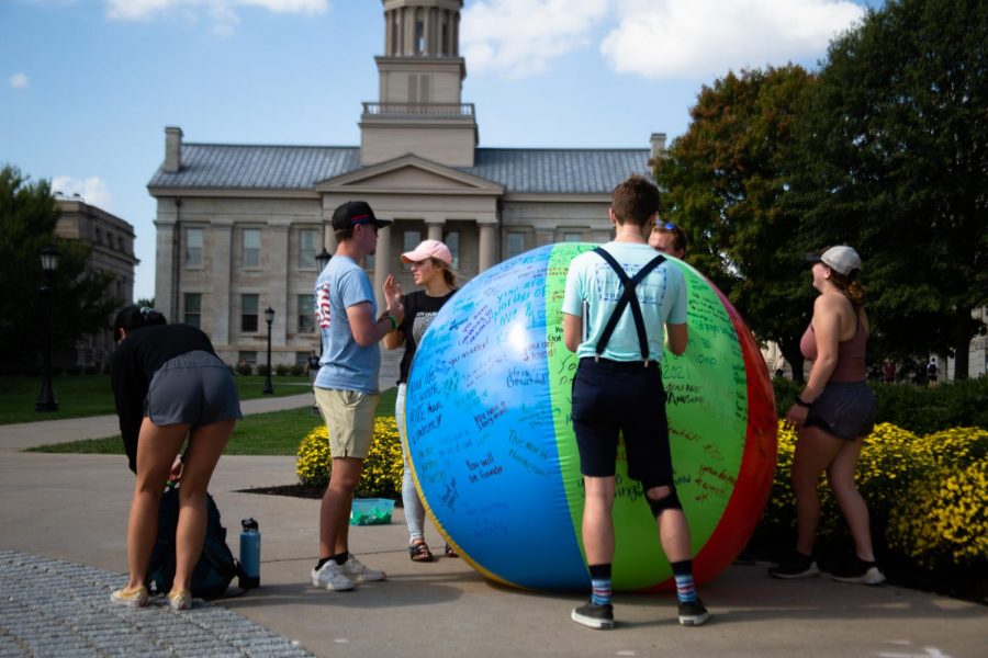 Green Bandana Project volunteers begin packing up their kindness ball at the University of Iowa on Thursday, Sept. 30, 2021. Students wrote encouraging messages on the ball regarding mental health.