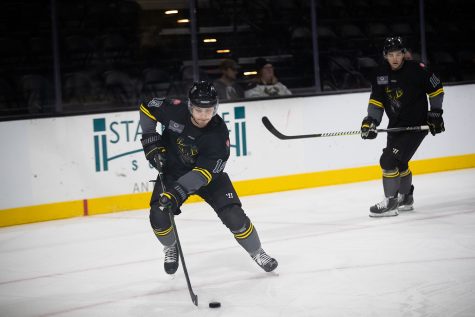 Forward Bryce Misley moves the puck during a hockey game between the Iowa Heartlanders and the Wheeling Nailers at the Xtream Arena in Coralville, Iowa on Wednesday, Oct. 27, 2021. The Wheeling Nailers defeated the Heartlanders 4-3. 
