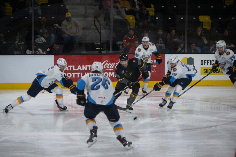 Iowa Heartlanders forward Zach Remers is surrounded by Toledo Walleye defenders during a game at Xtream Arena in Coralville on October 29th, 2021.