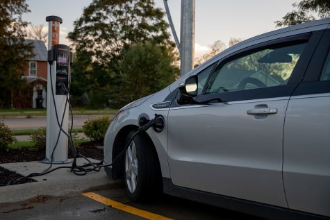 A Chevy Volt is shown being charged at a HyVee parking lot in Iowa City on Wednesday, Oct. 13, 2021 