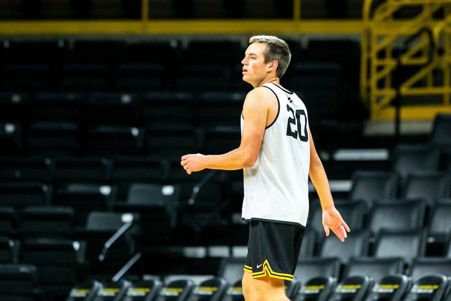 Iowa center Payton Sandfort (20) runs a drill during NCAA mens basketball practice, Monday, Oct. 11, 2021, at Carver-Hawkeye Arena in Iowa City, Iowa.