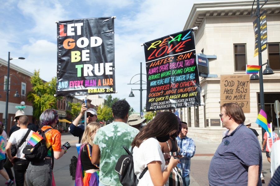 Anti-gay protestors engage in conversations with the LGBTQ community at the intersection of Washington and Dubuque Streets on Saturday, Oct. 2, 2021.