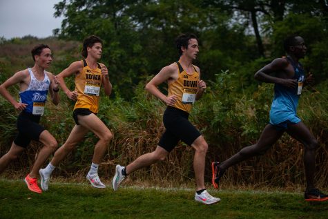 Iowa runners Nick Trattner (left) and Noah Healy (right) compete in the Hawkeye Invite meet at the Ashton Cross Country Course on Friday, Sept. 3, 2021. 