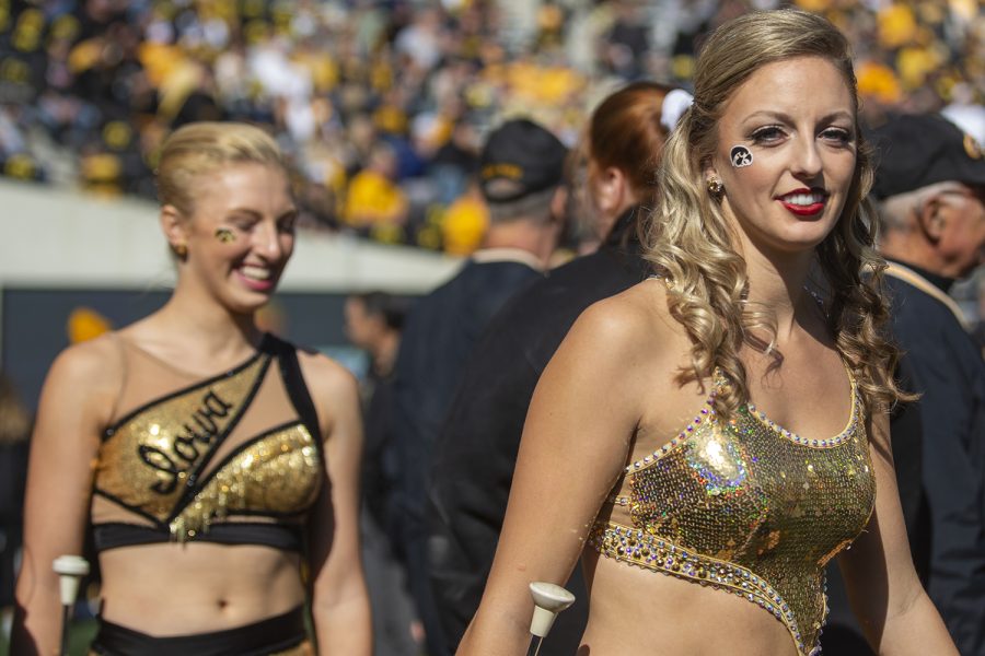 Iowa Golden Girls Kylene Spanbauer and Ella McDaniel walk onto the field before a football game between No. 2 Iowa and Purdue at Kinnick Stadium on Saturday, Oct. 16, 2021. The Boilermakers defeated the Hawkeyes 24-7. 