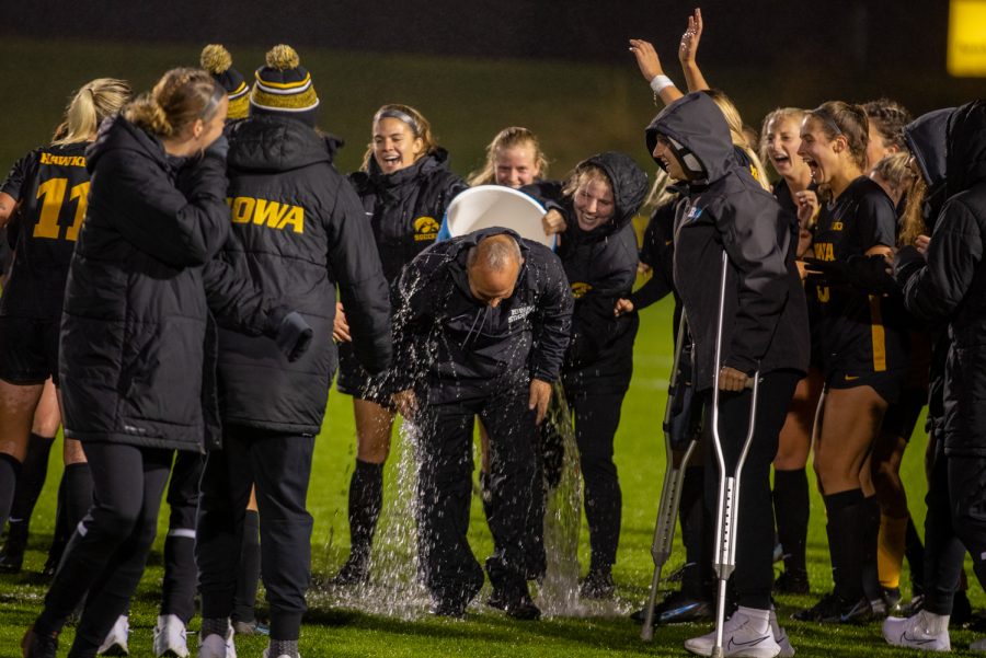 Head coach Dave Dilanni gets dumps with water after a soccer game between Iowa and Minnesota at the UI Soccer Complex in Iowa City on Thursday, Oct. 21, 2021.The Hawkeyes defeated the Gophers 1-0. This victory marks his 300th win. 