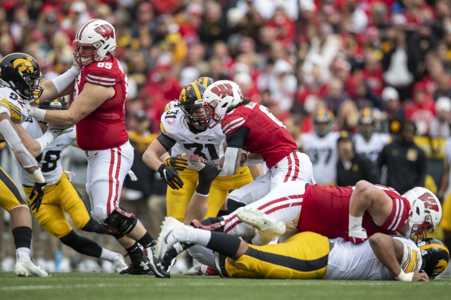Wisconsin running back Chez Mellusi braces for a hit from Iowa linebacker Jack Campbell during a football game between No. 9 Iowa and Wisconsin at Camp Randall Stadium on Saturday, Oct. 30, 2021. Mellusi rushed for 48 yards on 19 carries.The Badgers defeated the Hawkeyes 27-7. 
