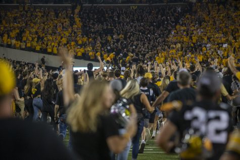 Iowa fans rush the field after a football game between No. 3 Iowa and No. 4 Penn State at Kinnick Stadium on Saturday, Oct. 9, 2021. The Hawkeyes defeated the Nittany Lions 23-20. 