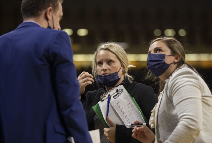 New Hampshire assistant coaches Derek Marchione and Mandy Pennewell speak with head coach Kelsey Hogan during a women’s basketball game between Iowa and New Hampshire at Carver-Hawkeye Arena in Iowa City on Tuesday, Nov. 9, 2021. The Hawkeyes defeated the Wildcats 93-50.