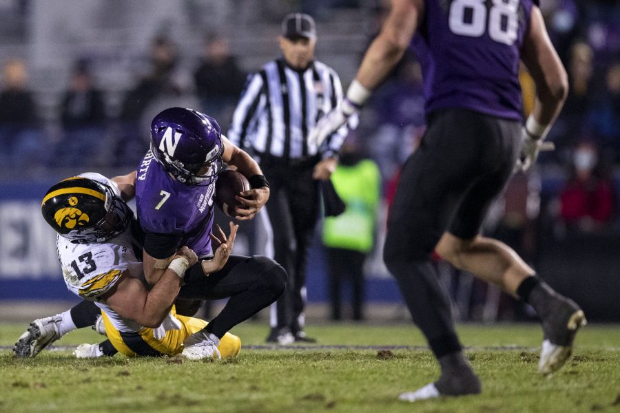 Iowa left end Joe Evans sacks Northwestern quarterback Andrew Marty during a football game between No. 19 Iowa and Northwestern at Ryan Field in Evanston, Illinois, on Saturday, Nov. 6, 2021. The Hawkeyes defeated the Wildcats 17-12. (Grace Smith/The Daily Iowan)