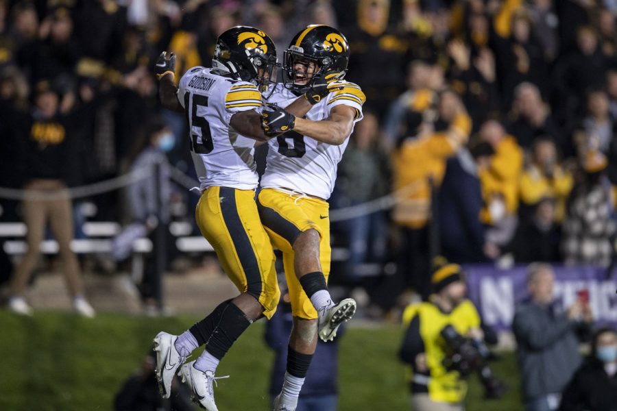 Iowa running back Tyler Goodson and quarterback Alex Padilla celebrate after a touchdown during a football game between No. 19 Iowa and Northwestern at Ryan Field in Evanston, Illinois, on Saturday, Nov. 6, 2021. Padilla replaced starting quarterback Spencer Petras during the first half. (Grace Smith/The Daily Iowan)