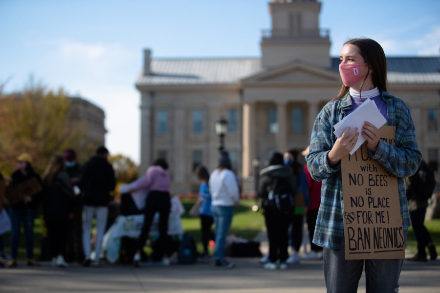 A protester looks to hand out flyers at a protest against pesticides held by the University of Iowa Environmental Coalition at the Pentacrest at the University of Iowa on Tuesday, Nov. 9, 2021. 